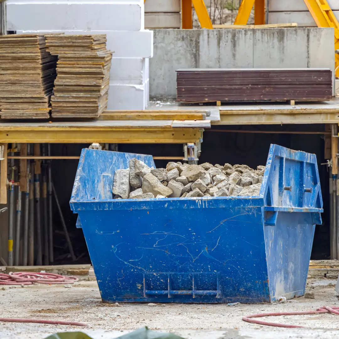 Commercial skip hire in poole filled with construction rubble at a building site by A1 Budget Skips