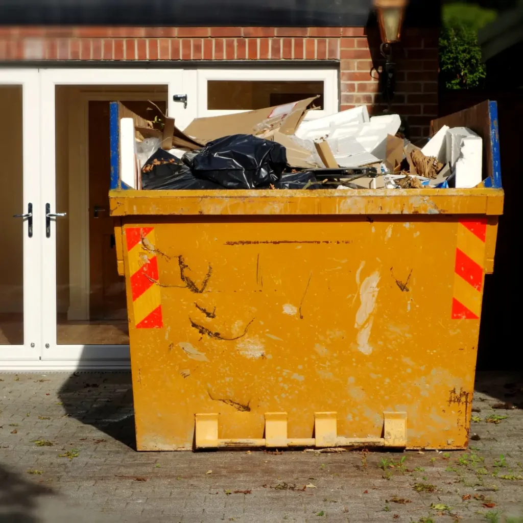 Domestic skip hire in poole filled with household waste outside a home by A1 Budget Skips